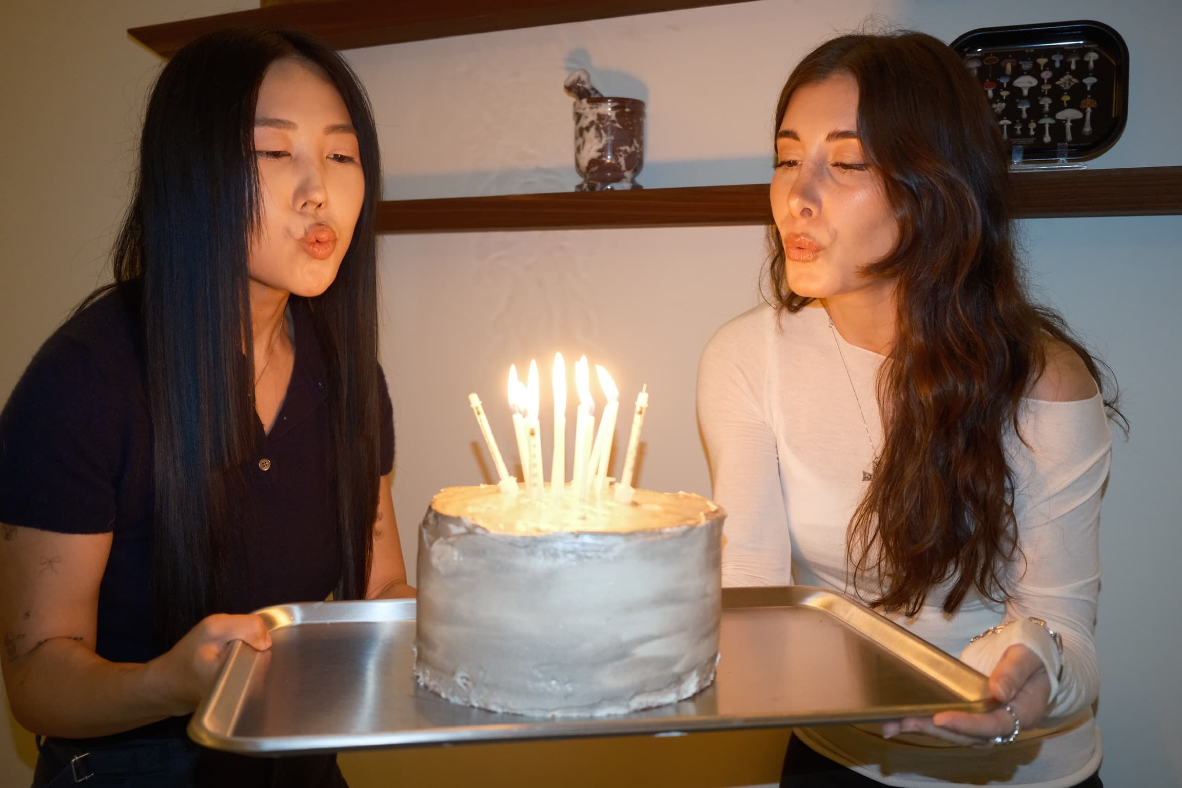 Two of the Saelo team blowing out the needle candles together