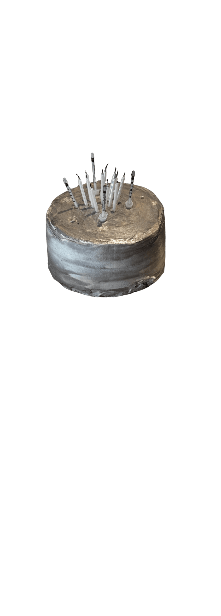 Cut-out of the brushed-silver cake topped with needles as candles