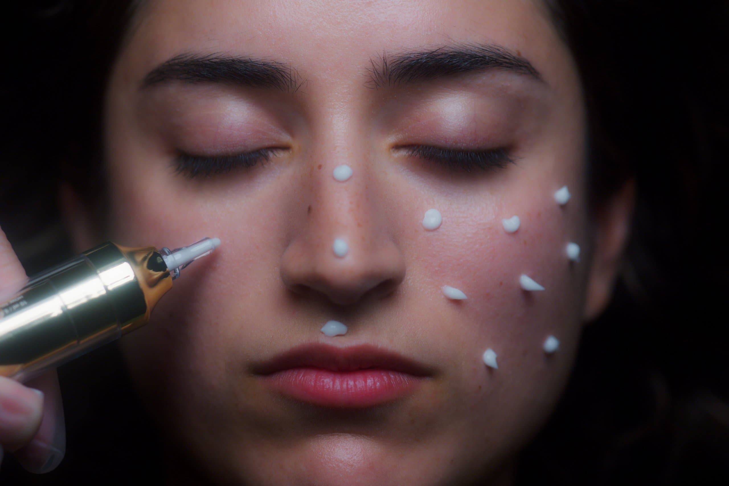 Close-up of injectable droplets placed across a face