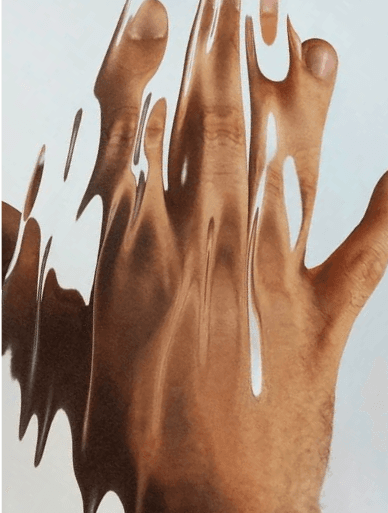 Cream running in ribbons down the back of a hand