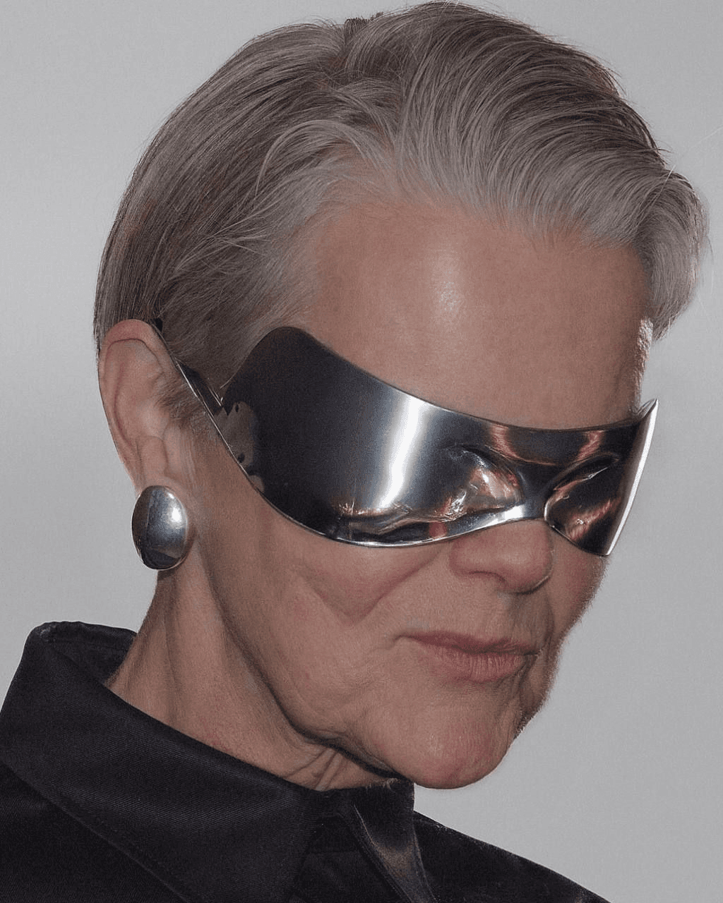 Model wearing wraparound metallic sunglasses
