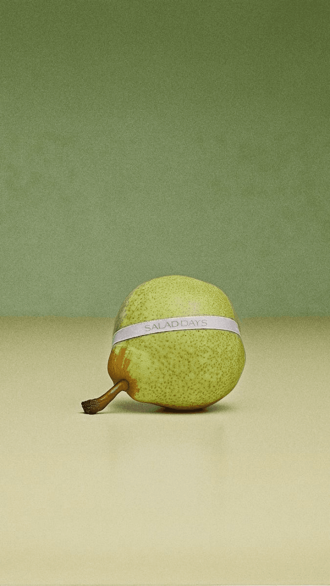 A pear banded with a plain label on a sage ground