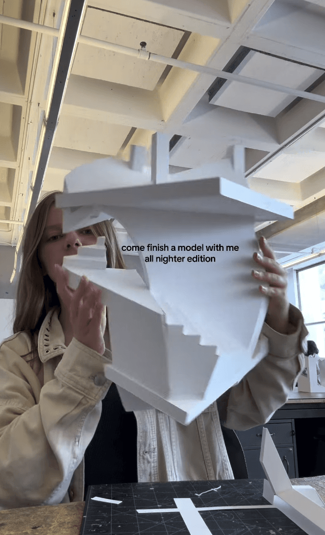 Person holding up a white 3D paper model